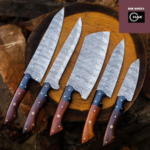 #knife #knifelife #knifestagram #knifemaking #knifemaker#knifepics #knifefanatics#edcknife #customknife #knifeparty #knifenuts #knifeart #knifefanatic #knifeaddiction #pocketknife #knifeobsession #chefknife #damascus #knife #knives #swordartonline #axe #leathersheath #christmas #knifefanatics #usa🇺🇸 #canada🇨🇦 #europe🇪🇺#spain🇪🇸#londonlife#turkey🇹🇷 #france🇫🇷 DETAILS Chef Knives Set 5 Pcs Damascus Steel Custom Handmade Personalised Gift Birthday Gift for Him Corporate Gifts Thanksgiving Gifts This Chef Knife Set Can enhance the beauty of your Kitchen also it can be a perfect Wedding gift, Father's Day gift, Mother's Day gift, Birthday Gift, Groomsmen gift, Christmas gift, Luxury Gifts For Men, Veteran Day Gift, Anniversary gift for husband, Thanksgiving Gift, Gift for her, Gift for him, Easter Gifts, Independence Day, Groomsmen Gifts or gift for any Occasion. Sizes: Cleaver Knife 12" Inch Overall With 7 " Inch Blade Chef Knife 13 " Inch overall With 8" Inch Blade Santoku Knife 11" Inch Overall 6" Inch Blade Paring Knife 9.5" Inch Overall 4.5" Inch Blade Fillet / Boning Knife 12.5" Inch Overall 7.5" Inch Blade Material: 400 Layer Full Tang Damascus Steel (1095 High Carbon Steel and 15n20 Forged Steel) Leather Bag: 100% Soft Cowhide Leather Hardness: 60-62 HRC Handle: WOOD WITH MOSAIC PIN HANDLE How to Care For Your New Knife: Our knives are 100% hand forged from premium high carbon steel which results in a high carbon content blade and long lasting edge retention. High carbon Damascus steel blades will begin to form a patina (a slight color change) with use which helps to stabilize freshly forged blades and become more rust resistant overtime 1- Store in a dry place 2- After use, wash & dry the blade with paper towel or cotton cloth 3- Apply any cooking oil on the blade 4- Do not put the knife in sheath for very long time, leather sheath absorbs moister and knife can get rusted 5- If you knife get rust, gently clean it with vinegar and soap. If rust is deep then try to use WD-40 and wipe the knife blade with soft cloth 6- You must be 18+ to buy my products 7- Please open box carefully as these knives are sharp and ready to use.